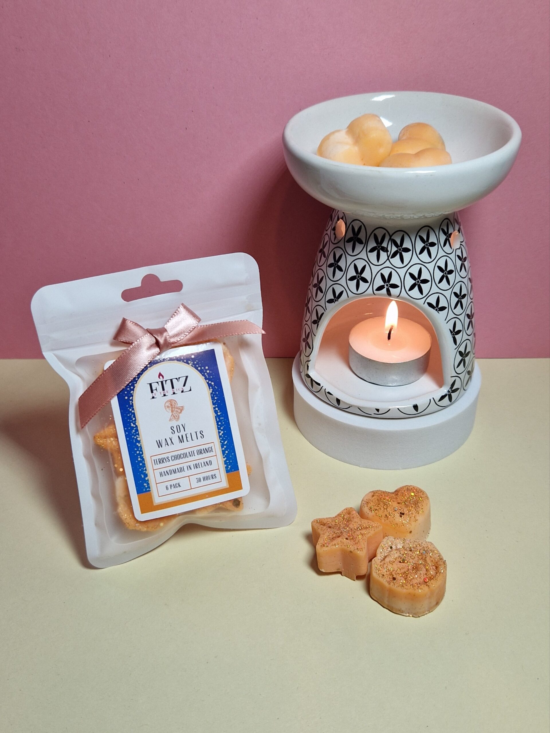 Terry's Chocolate Orange wax melts in a packet next to a wax burner