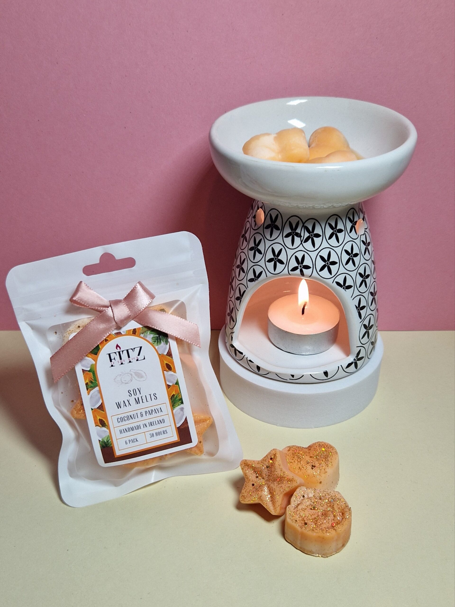 Coconut & Papaya wax melts in a packet next to a wax burner