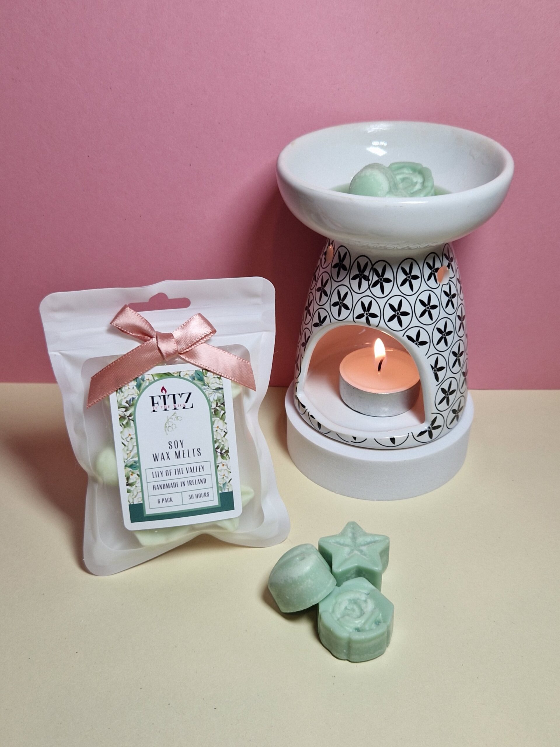 Lily of the Valley wax melts in a packet next to a wax burner