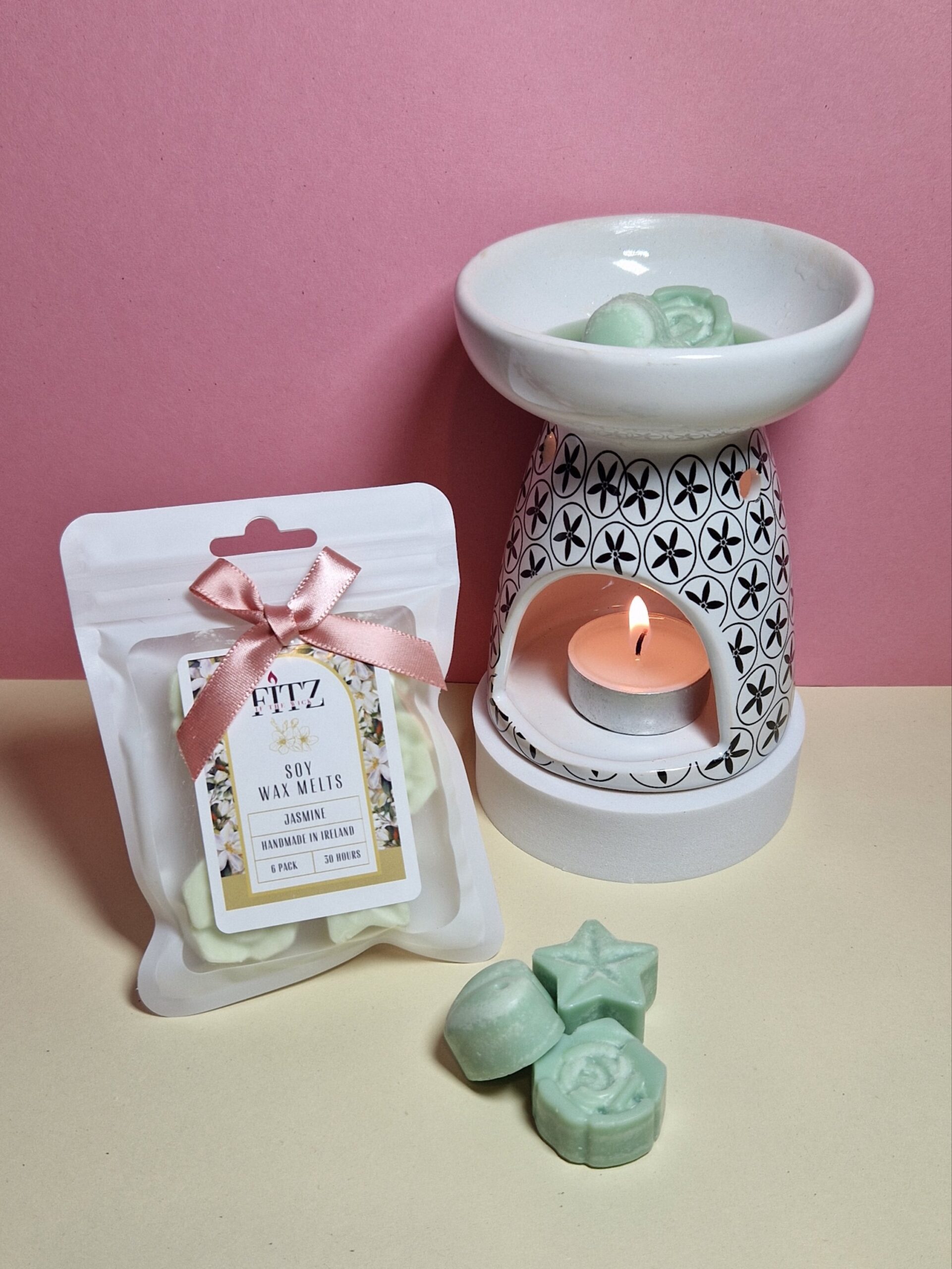 Jasmine wax melts in a packet next to a wax burner