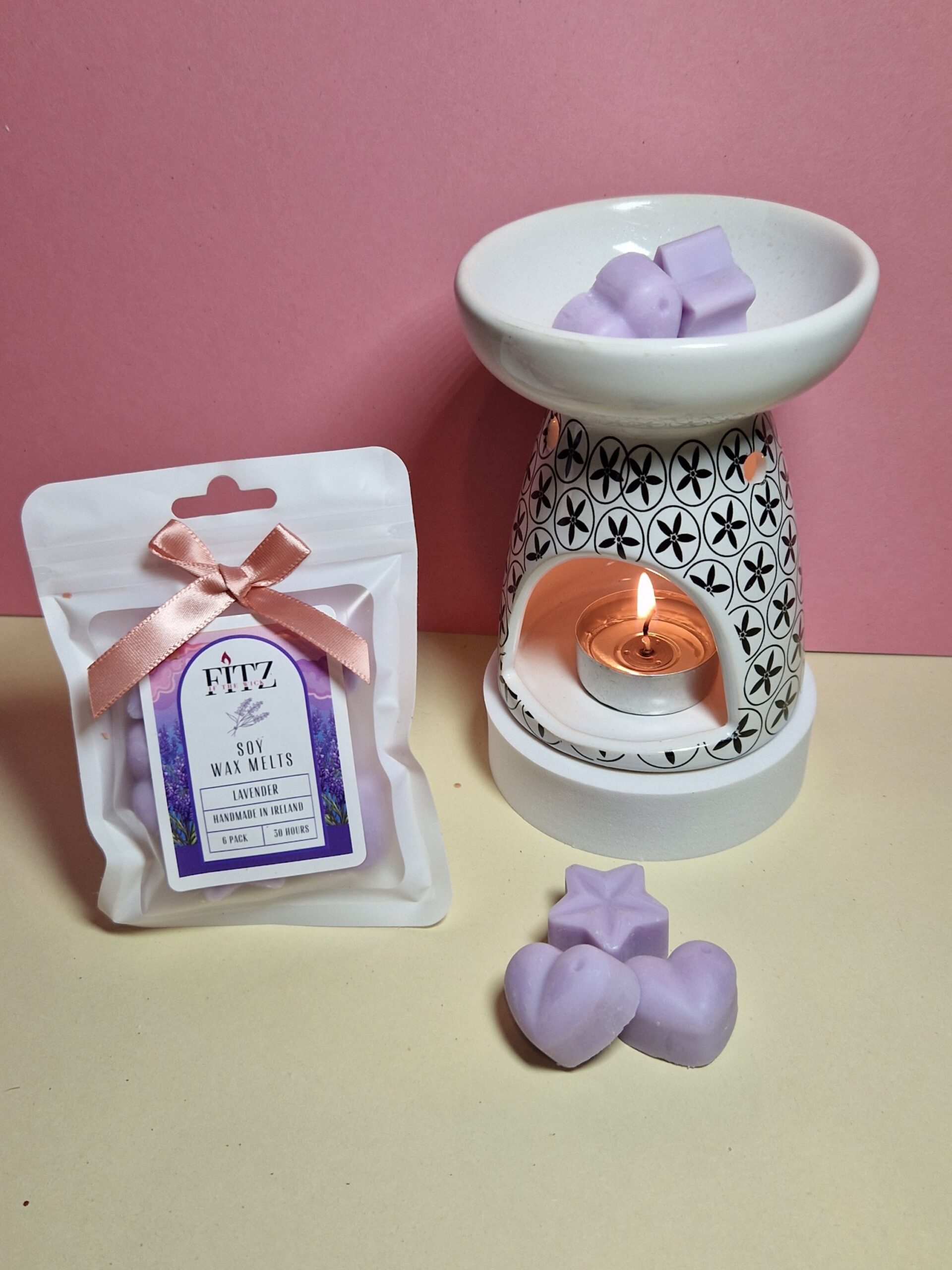 Lavender wax melts in a packet next to a wax burner