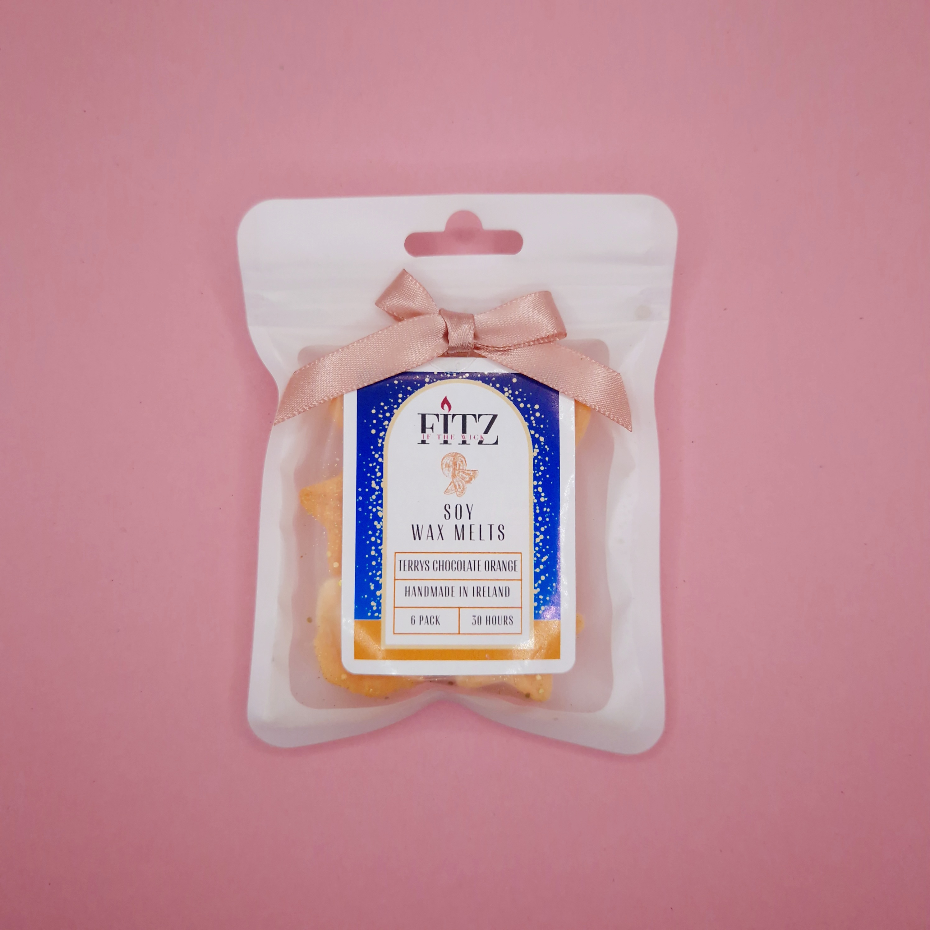 chocolate orange wax melts on pink paper
